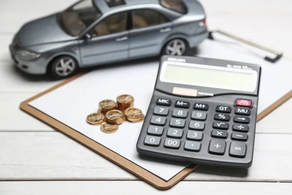 a toy car, calculator and coins