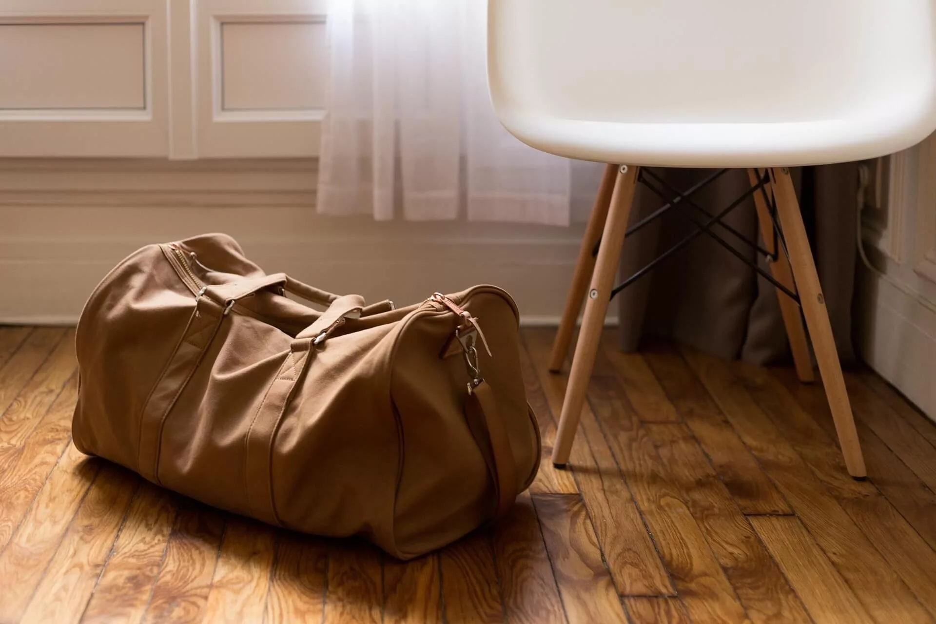 Brown Suitcase on the floor with a paj suitcase tracker