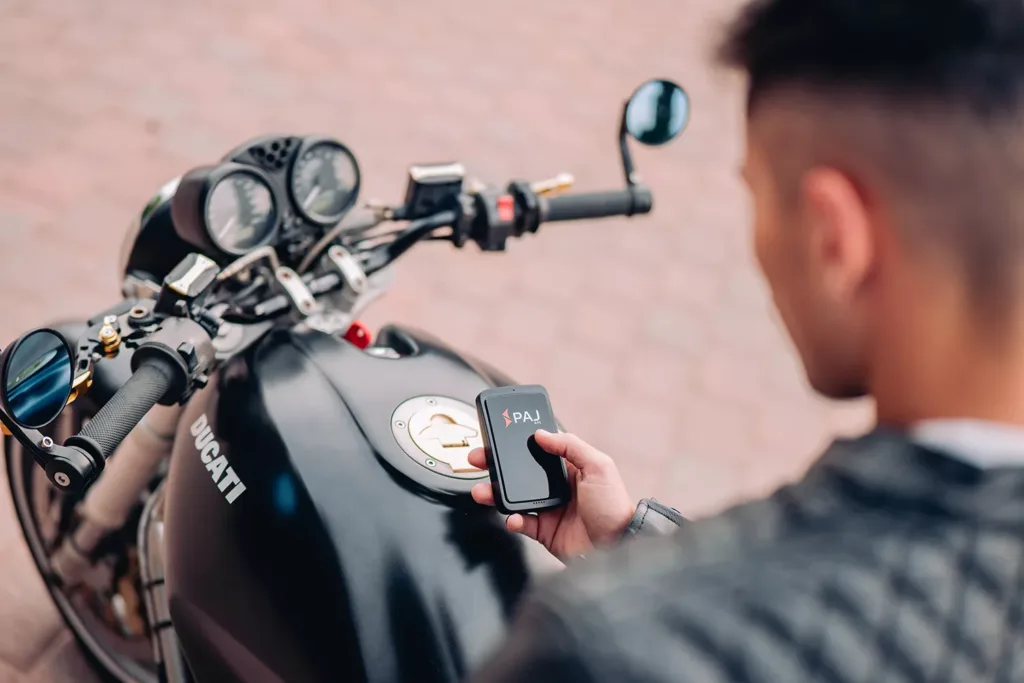 a man sitting in motorbike holding allround finder