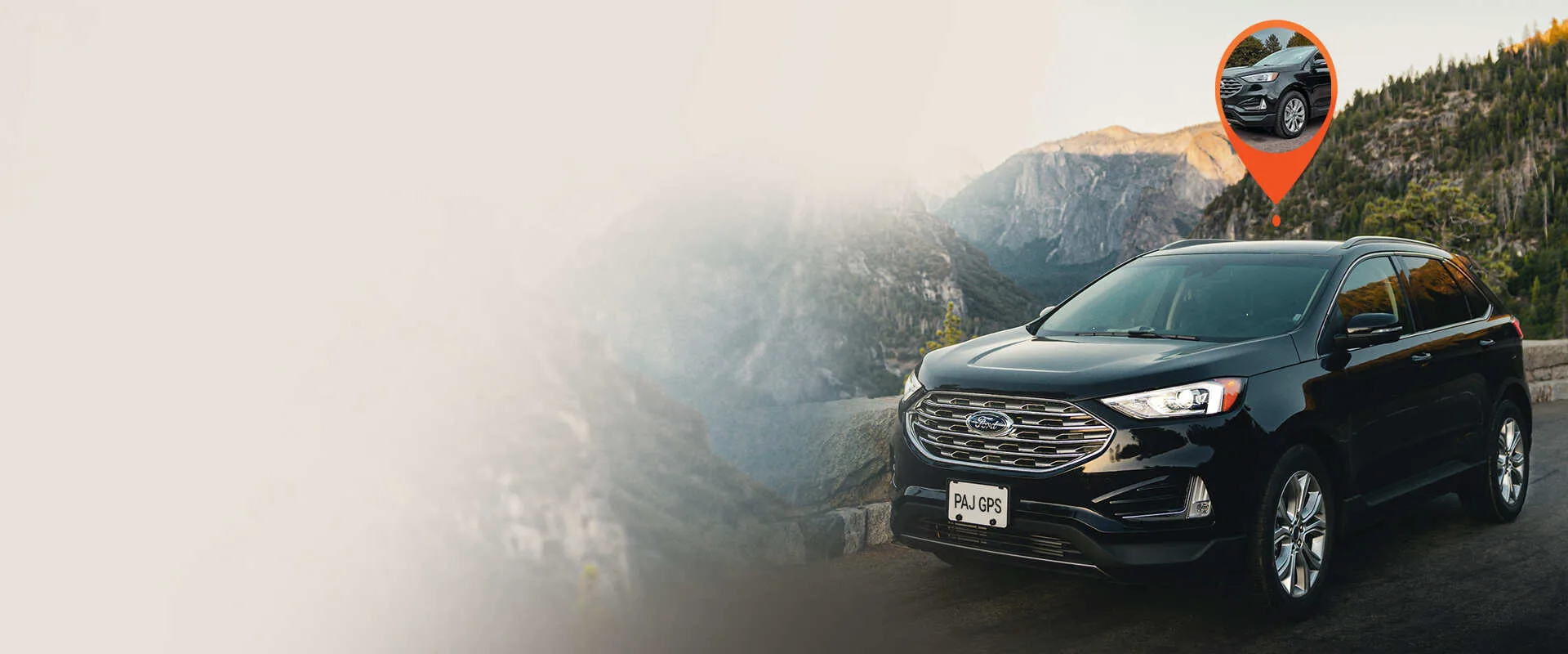 a black car running trough mountains protected by paj gps hidden tracker