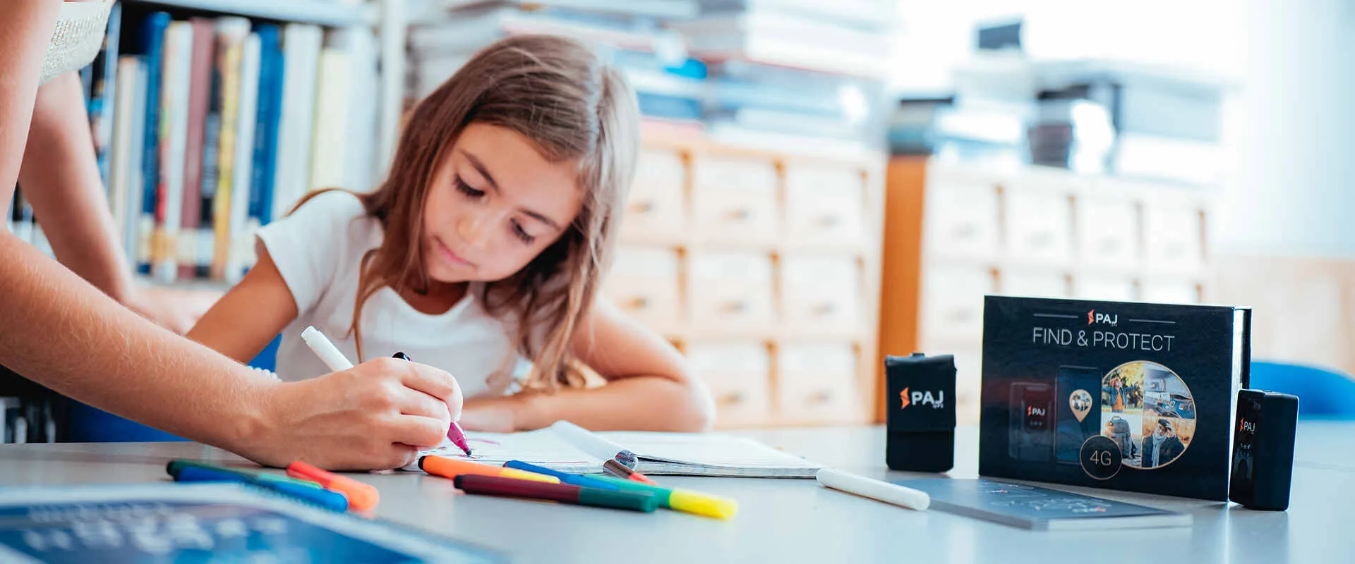 A girl writing protected by personal tracking device