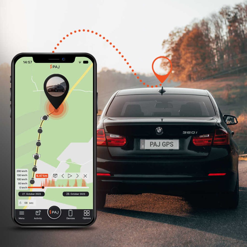 A black car on road and on its side a mobile running paj finder portal application with hidden GPS tracking device for cars