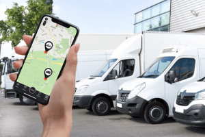 a hand holding mobile with PAJ GPS tracker for business.