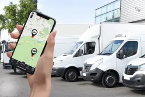 a hand holding mobile with PAJ GPS tracker for business.