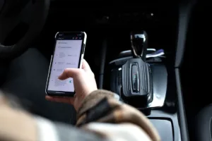 person sitting inside a car learning how to track a car using paj gps