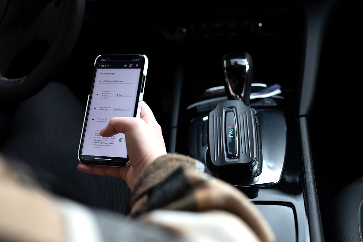 person sitting inside a car learning how to track a car using paj gps