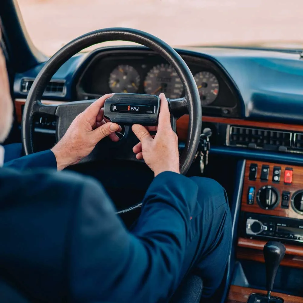 tracker car tracking Man holding power finder 4g GPS tracker while sitting inside the driver seat of his car