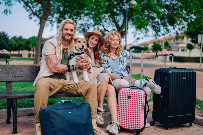 family happily sitting with there luggage tracker for android