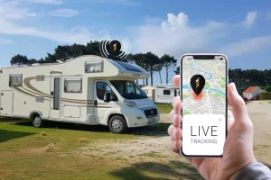 Motorhome in the background andphone in the foreground where the live location of the motorhome displayed