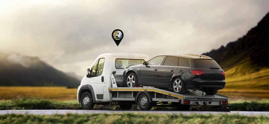 A towing vechile moving through road with tow tracker set on it