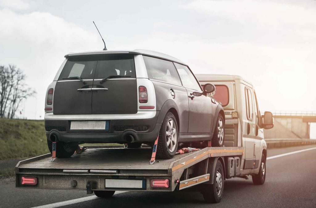 a car towed by towing vehicle