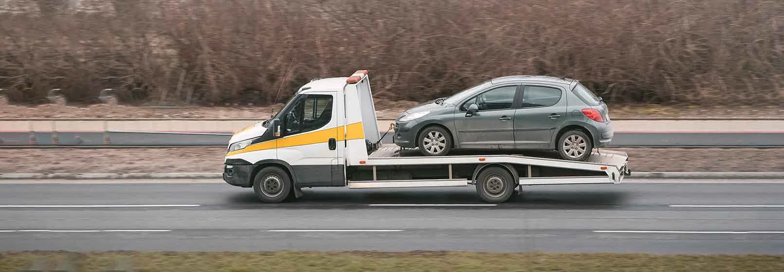 towing vehicle moving through road