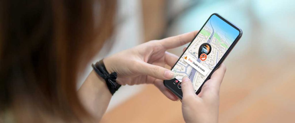 A girl looking at mobile and wondering about GPS tracking mistakes to avoid.
