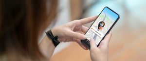 A girl looking at mobile and wondering about GPS tracking mistakes to avoid.
