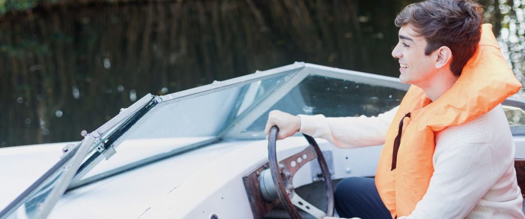 A man riding a boat .Do you need a license to drive a boat In the US.