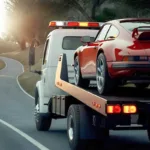 A car is towed on a truck