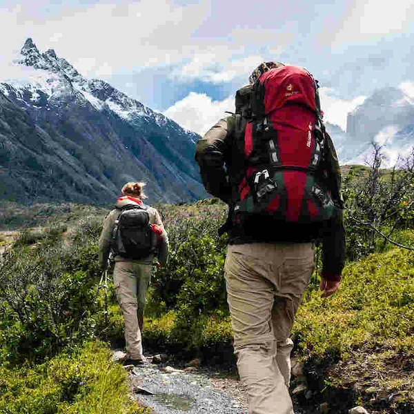 Two people hiking mountains with Hiking GPS tracker